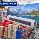 A shopping cart holding a boxed TV, a soundbar and wrapped gifts in a warehouse store aisle, with the headline Black Friday Lands Nov 27